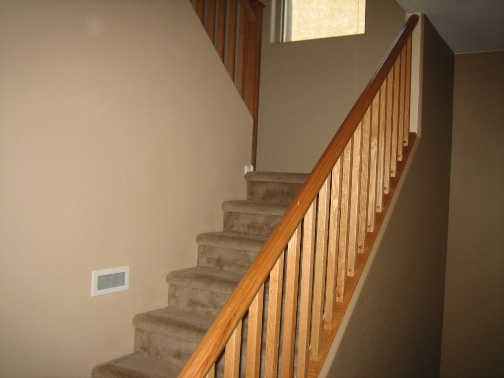 6912 West Carson Road Laveen, AZ 85339 - Photo 4 of 24 a view of staircase with wooden floor and white walls