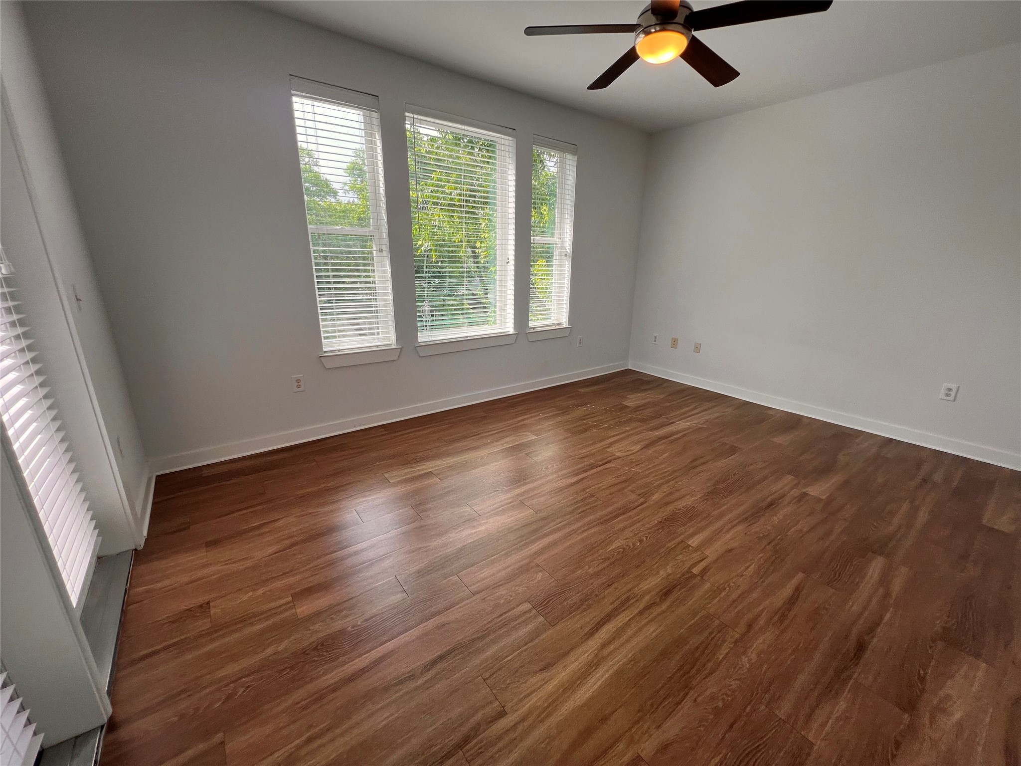 1900 Barton Springs Road, Unit 4041 Austin, TX 78704 - Photo 8 of 35 an empty room with wooden floor and windows