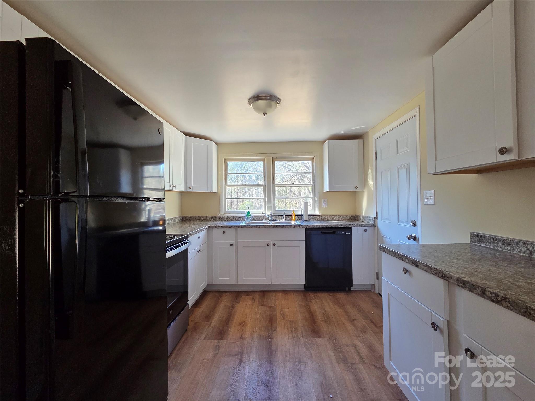 8334 Oak Tree Road Sharon, SC 29742 - Photo 5 of 15 a kitchen with granite countertop a refrigerator stove top oven and sink