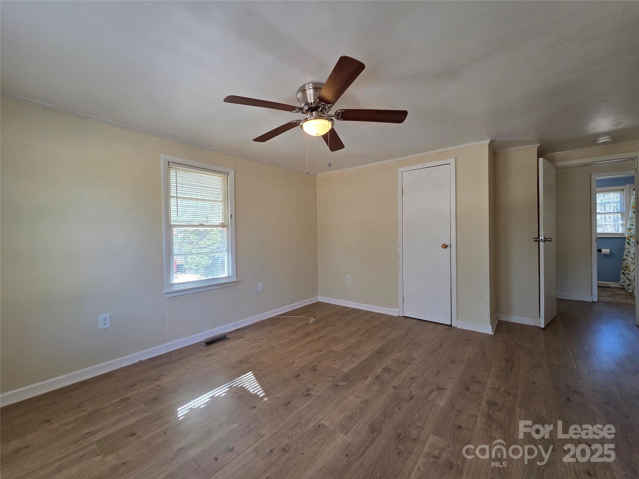 8334 Oak Tree Road Sharon, SC 29742 - Photo 9 of 15 a view of empty room with wooden floor and fan