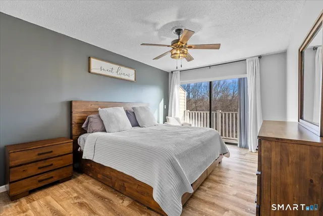 a bedroom with bed and a chandelier