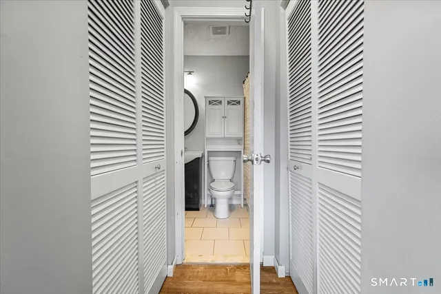 a bathroom with a sink a toilet and mirror