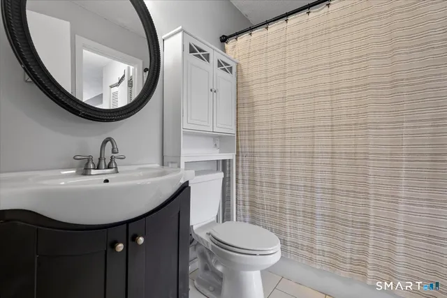 a bedroom with a bed and a tv