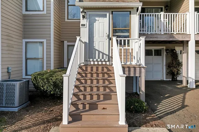 a view of stairs and hall with wooden floor