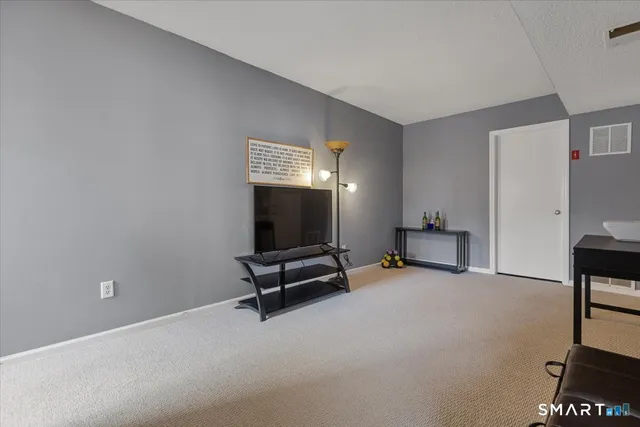 a view of a room with gym equipment and windows