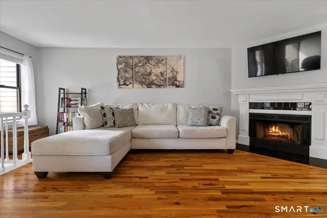 a living room with furniture and a wooden floor