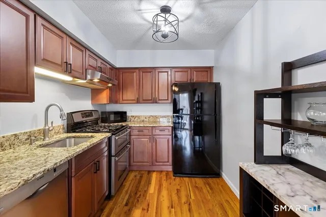 a kitchen with a stove a sink and cabinets