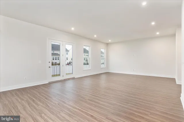 a view of a dining room with furniture wooden floor and windows