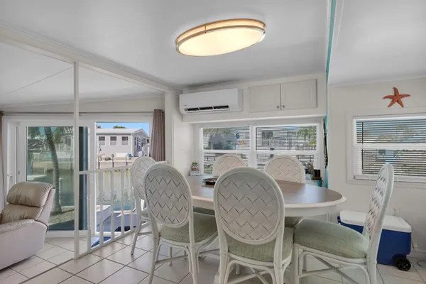 a dining room with furniture a livingroom view and wooden floor