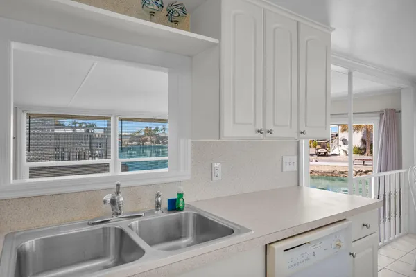 a kitchen with white cabinets and a sink