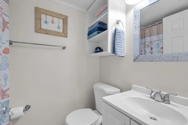 a white toilet sitting next to a bathroom sink