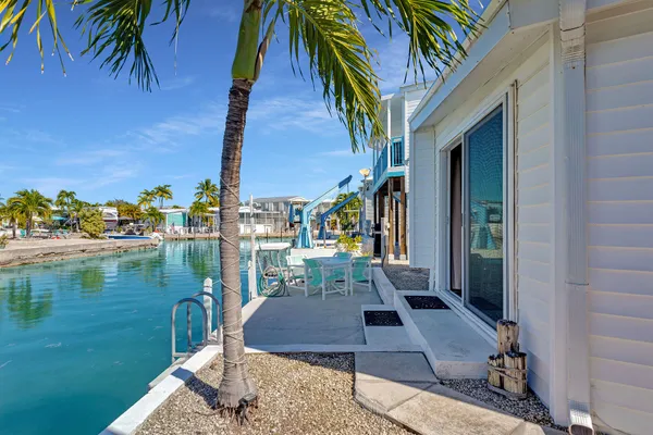 a view of a swimming pool with a patio and a yard