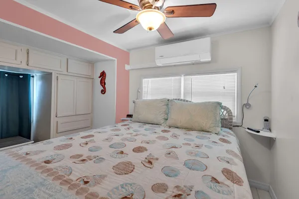 a bedroom with a large bed and a chandelier