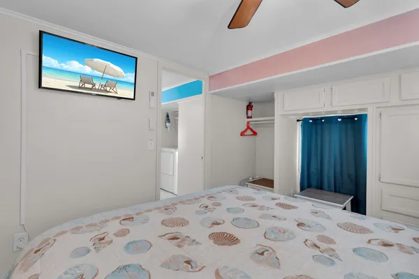 a bedroom with a bed and a painting on the wall