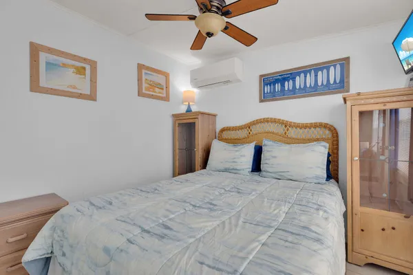 a bedroom with a large bed and a chandelier