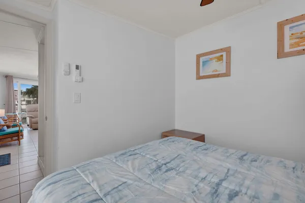 a bedroom with a bed and painting on the wall