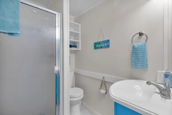 a bathroom with a sink toilet and shower