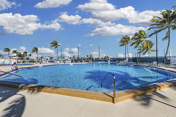 a view of swimming pool with outdoor seating and plants