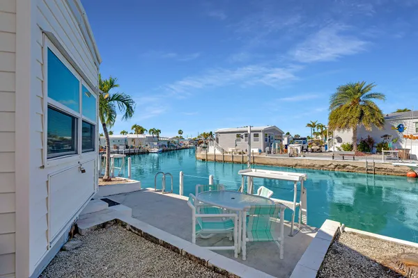 a balcony with table and chairs