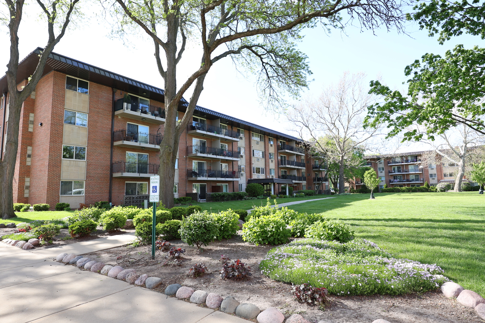 2230 South Goebbert Road, Unit 139 Arlington Heights, IL 60005 - Photo 1 of 14 a view of a big yard with plants and large trees
