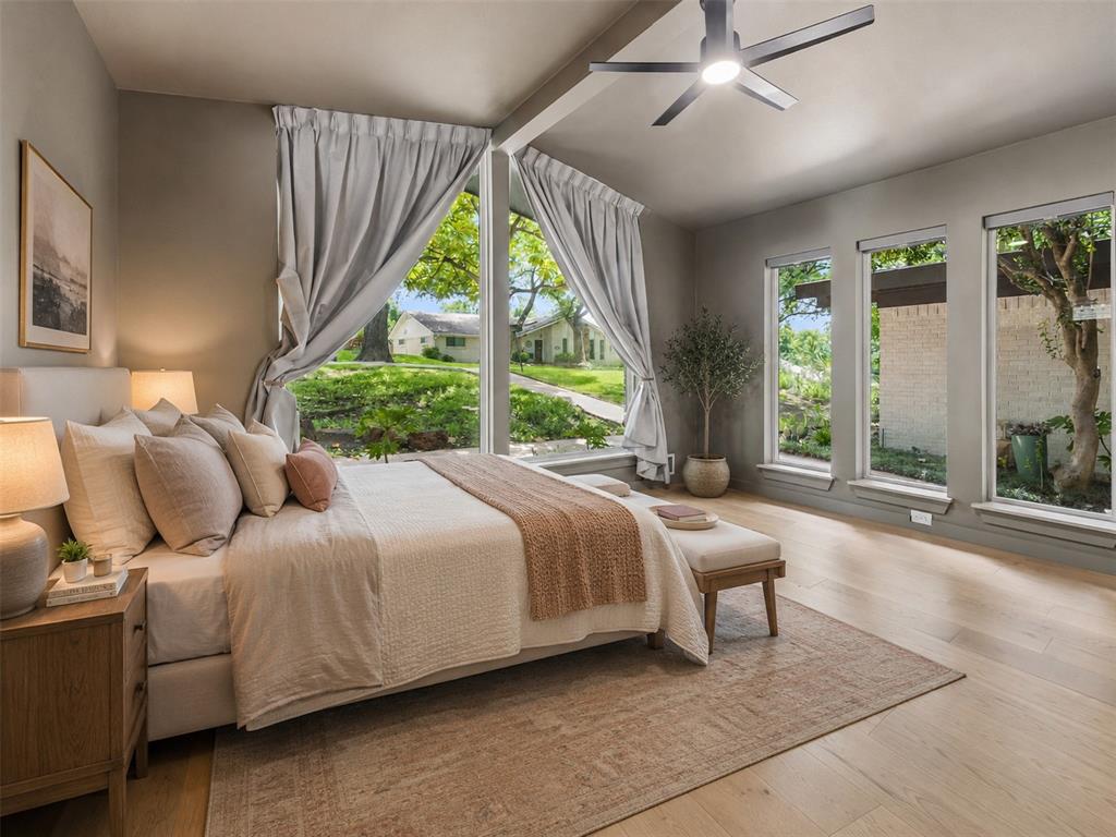 13321 Purple Sage Road Dallas, TX 75240 - Photo 5 of 30 AI Augmented Spacious bedroom featuring large picture windows, wood-finish flooring, and a modern ceiling fan