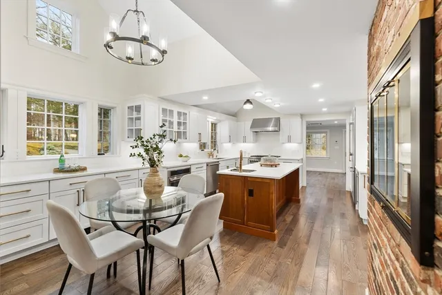 a large kitchen with a table and chairs