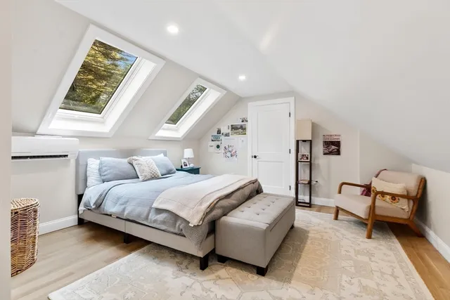 a spacious bedroom with a bed and a window