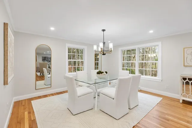 a living room with white walls furniture and a window