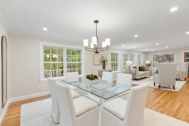 a living room with fireplace furniture and a chandelier