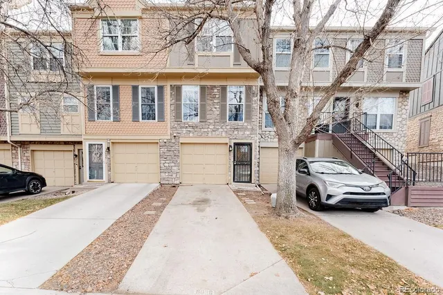 a car parked in front of a white building