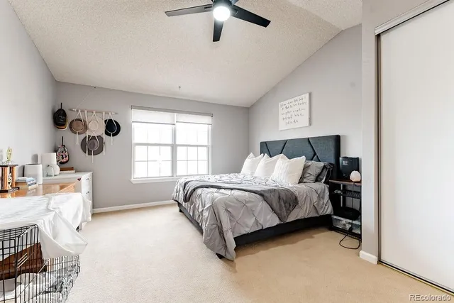 a spacious bedroom with a bed and a window