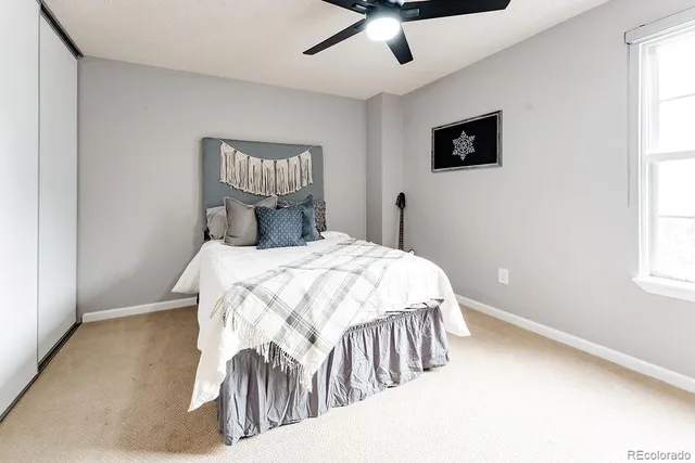 a bedroom with a bed and window