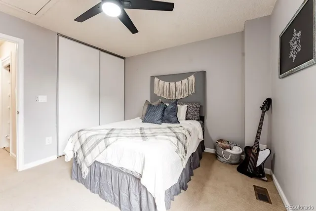 a bedroom with bed and a chandelier