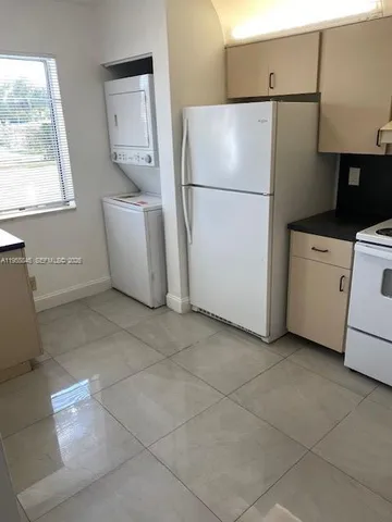 a white refrigerator freezer sitting in a kitchen