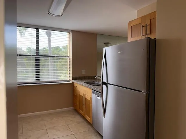 a kitchen with granite countertop a stove top oven and cabinets