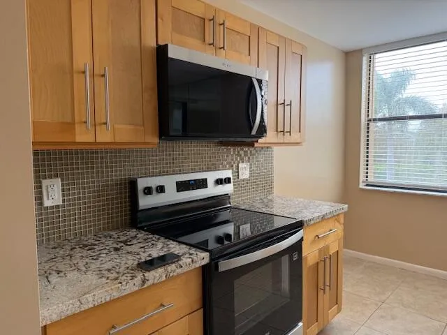 a kitchen with a stove and a microwave
