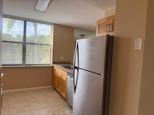 a kitchen with stainless steel appliances granite countertop white cabinets a microwave oven and a sink