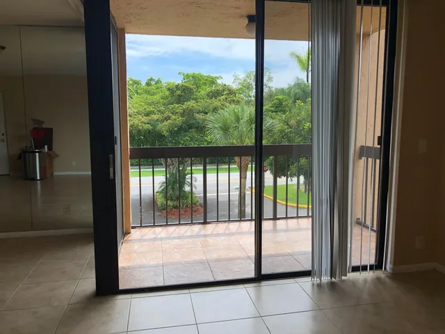 a view of a glass door with a yard from a window