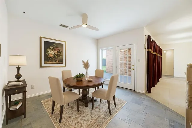 a kitchen with stainless steel appliances granite countertop a stove top oven a sink dishwasher and a refrigerator with wooden cabinets