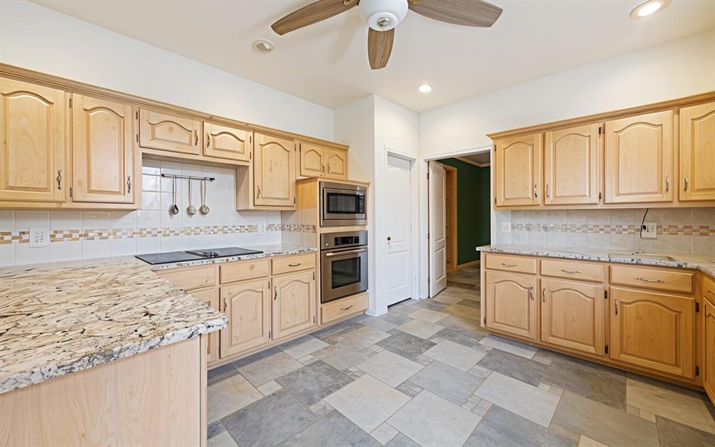2604 Spring Lake Drive Richardson, TX 75082 - Photo 14 of 34 a kitchen with granite countertop cabinets and stainless steel appliances