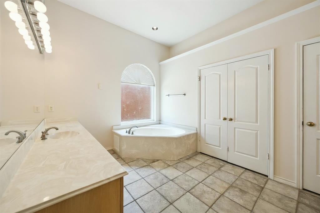 2604 Spring Lake Drive Richardson, TX 75082 - Photo 19 of 34 a bathroom with a sink and a mirror