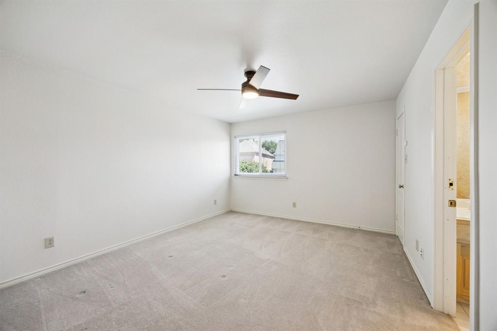 2604 Spring Lake Drive Richardson, TX 75082 - Photo 21 of 34 an empty room with chandelier fan and windows