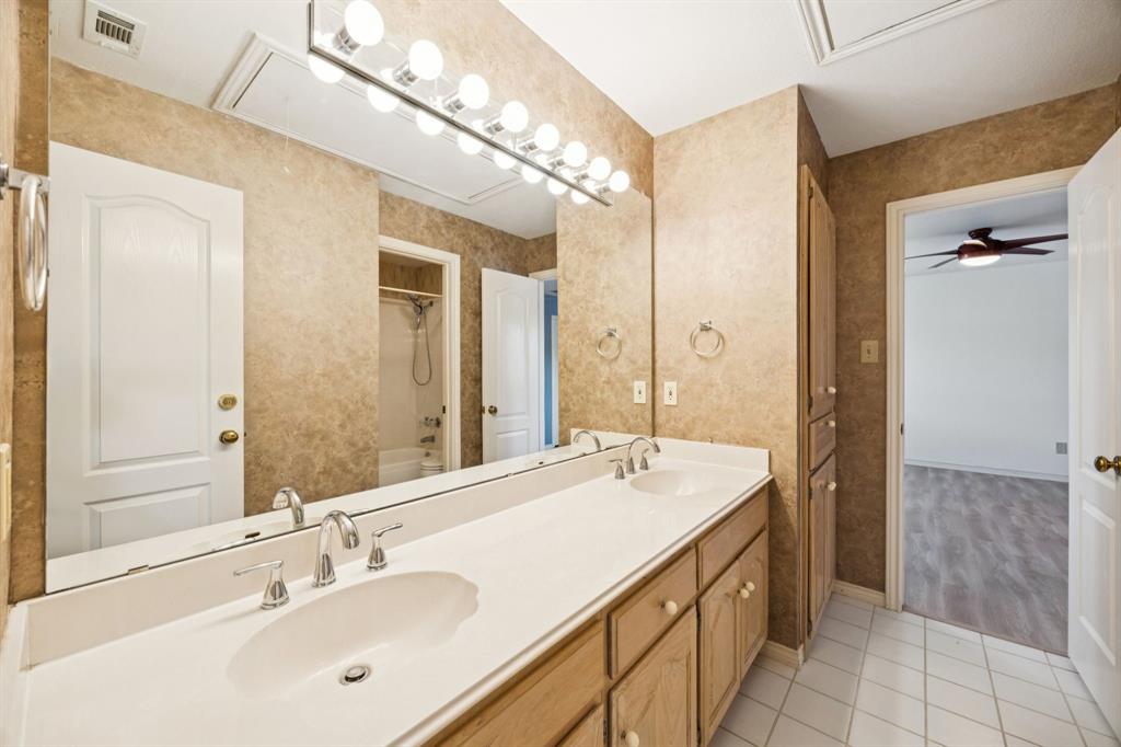 2604 Spring Lake Drive Richardson, TX 75082 - Photo 22 of 34 a bathroom with a sink double vanity and a mirror