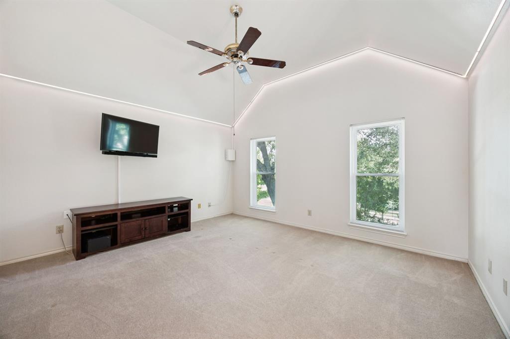 2604 Spring Lake Drive Richardson, TX 75082 - Photo 24 of 34 an empty room with windows fireplace and a ceiling fan