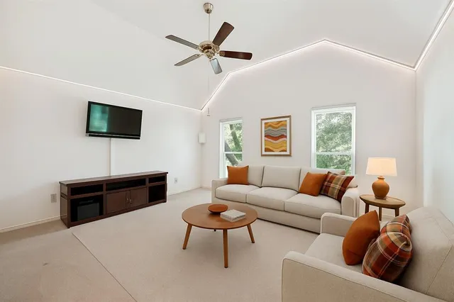 a view of a livingroom with a ceiling fan and entryway