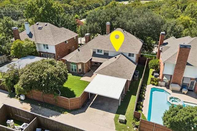 an aerial view of residential houses with outdoor space