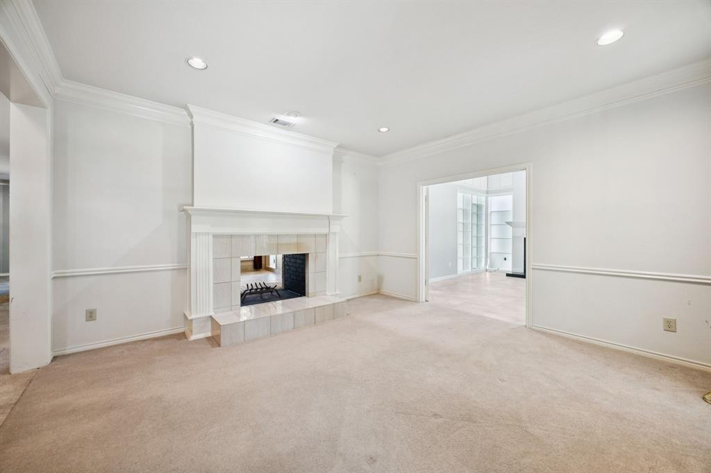 2604 Spring Lake Drive Richardson, TX 75082 - Photo 4 of 34 a view of a livingroom with an empty space and a fireplace
