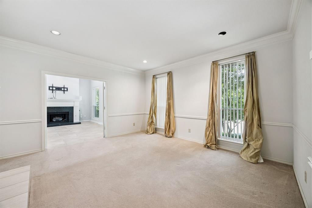 2604 Spring Lake Drive Richardson, TX 75082 - Photo 5 of 34 a view of an empty room with a fireplace and a window