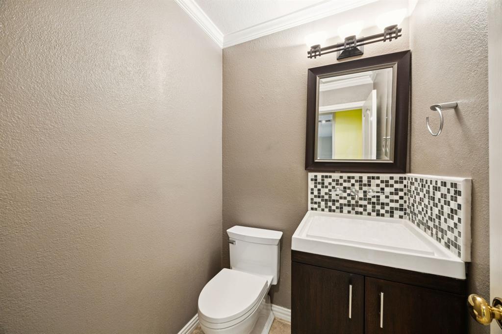 2604 Spring Lake Drive Richardson, TX 75082 - Photo 6 of 34 a bathroom with a toilet sink and mirror