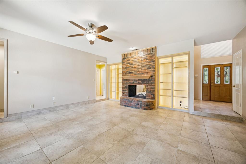 2604 Spring Lake Drive Richardson, TX 75082 - Photo 8 of 34 a view of an empty room with a fireplace and a window